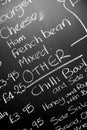 Hand written chalk menu board featureing various ingredients