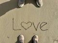 hand written love word on sandy beach Royalty Free Stock Photo