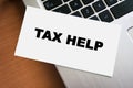 A hand-written note reading TAX HELP placed on a laptop keyboard, emphasizing tax assistance and support for individuals Royalty Free Stock Photo