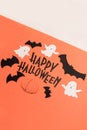 Hand written phrase Happy Halloween with traditional symbols near it