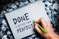 Hand wrtiting `Done is better than perfect` on a block Royalty Free Stock Photo