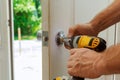 Hand & x27;s man with screwdriver Installs door knob. Royalty Free Stock Photo