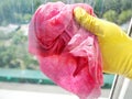 Hand in yellow glove cleaning window glass Royalty Free Stock Photo