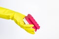 Hand with yellow glove holding red sponge for cleaning on white background Royalty Free Stock Photo