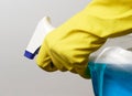 Hand in yellow glove holding spray bottle Royalty Free Stock Photo