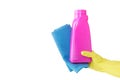 Hand in yellow glove holds pink bottle of liquid detergent and blue rag for duston white background. cleaning Royalty Free Stock Photo