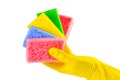 A hand in a yellow glove holds a set of sponges isolated on a white background. Washing dishes, cleaning, home cleaning Royalty Free Stock Photo