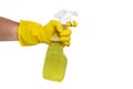 A hand in yellow rubber gloves holds a spray bottle with a cleaning or detergent on a white background. Rubber gloves isolate Royalty Free Stock Photo