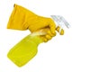 A hand in yellow rubber gloves holds a spray bottle with a cleaning or detergent on a white background. Rubber gloves isolate Royalty Free Stock Photo