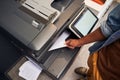 Man holding paper while using photocopy machine Royalty Free Stock Photo