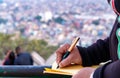 Hand of a young businessman taking notes with a fountain pen on a notecopy.  Student learning online. Blogger. selective focus Royalty Free Stock Photo