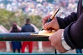 Hand of a young businessman taking notes with a fountain pen on a notecopy.  Student learning online. Blogger. selective focus Royalty Free Stock Photo