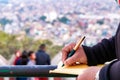 Hand of a young businessman taking notes with a fountain pen on a notecopy.  Student learning online. Blogger. selective focus Royalty Free Stock Photo