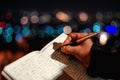 Hand of a young businessman taking notes with a fountain pen on a notecopy.  Student learning online. Blogger. selective focus Royalty Free Stock Photo