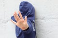 hand of young girl with hoodie protecting herself