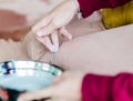 Hand of a young girl who decorates the dhuni in the period of Guru Purnima