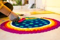 Hand of young indian girl making rangoli from colored powder on diwali eve Royalty Free Stock Photo