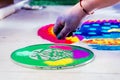 Hand of young indian girl making rangoli from colored powder on diwali eve Royalty Free Stock Photo