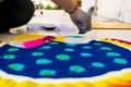 Hand of young indian girl making rangoli from colored powder on diwali eve Royalty Free Stock Photo