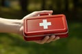 Hand of a young man firmly holding a first aid kit