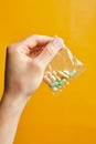 Hand of a young man holding a pills Royalty Free Stock Photo