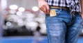 man wear blue jeans put or take out credit card in pocket on bokeh background. Young man takes out blank business Royalty Free Stock Photo