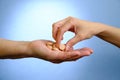 Hand of young woman and elderly woman holding the pills Royalty Free Stock Photo