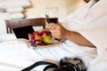 The hand of Young woman that hold wine glass And Sit play laptop In a luxurious room Ready Fruit Royalty Free Stock Photo