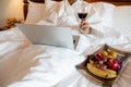 The hand of Young woman that hold wine glass And Sit play laptop In a luxurious room Ready Fruit Royalty Free Stock Photo