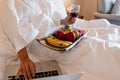 The hand of Young woman that hold wine glass And Sit play laptop In a luxurious room Ready Fruit Royalty Free Stock Photo