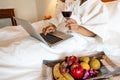 The hand of Young woman that hold wine glass And Sit play laptop In a luxurious room Ready Fruit Royalty Free Stock Photo