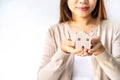 Hand of young woman holding wooden house model, Real estate concept Royalty Free Stock Photo