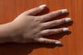 Hand of a young woman with nail extensions