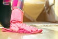 The hand of a young woman in a pink rubber glove holds a soft rag washes the floor. Home cleaning, washing floors Royalty Free Stock Photo