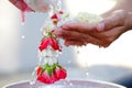 Hand of young woman pour water and flowers on the hands. older women and happy for the songkran festival. concept gives blessing