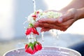 Hand of young woman pour water and flowers on the hands. older women and happy for the songkran festival. concept gives blessing