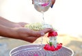 Hand of young woman pour water and flowers on the hands. older women and happy for the songkran festival. concept gives blessing