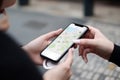 Hand of young woman searching location in map online on smartphone AI generated