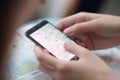 Hand of young woman searching location in map online on smartphone AI generated