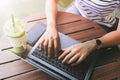 hand of young woman typing on laptop for working at coffee shop Royalty Free Stock Photo