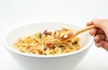 Hand of a young woman with a wood spoon of breakfast cereal