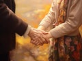 Hand of younger woman holding hand elderly woman,