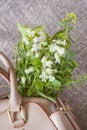 Handbag bag with with bouquet of summer flowers on canva background