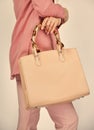 Handbag considerations. girl presenting clutch. sexy woman with stylish look. fashionable woman with trendy leather bag