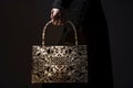 handbag with intricate lacework held by creator