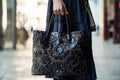 handbag with intricate lacework held by creator