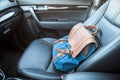 Handbag lying on front passenger seat of car, nobody