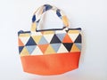 Handbag woven with colorful triangular patterned fabric combined with synthetic leather