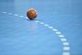 Handball ball laying on the 9 meters dotted line Royalty Free Stock Photo