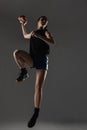 Handball player posing on gray background. Girl jumping with ball Royalty Free Stock Photo